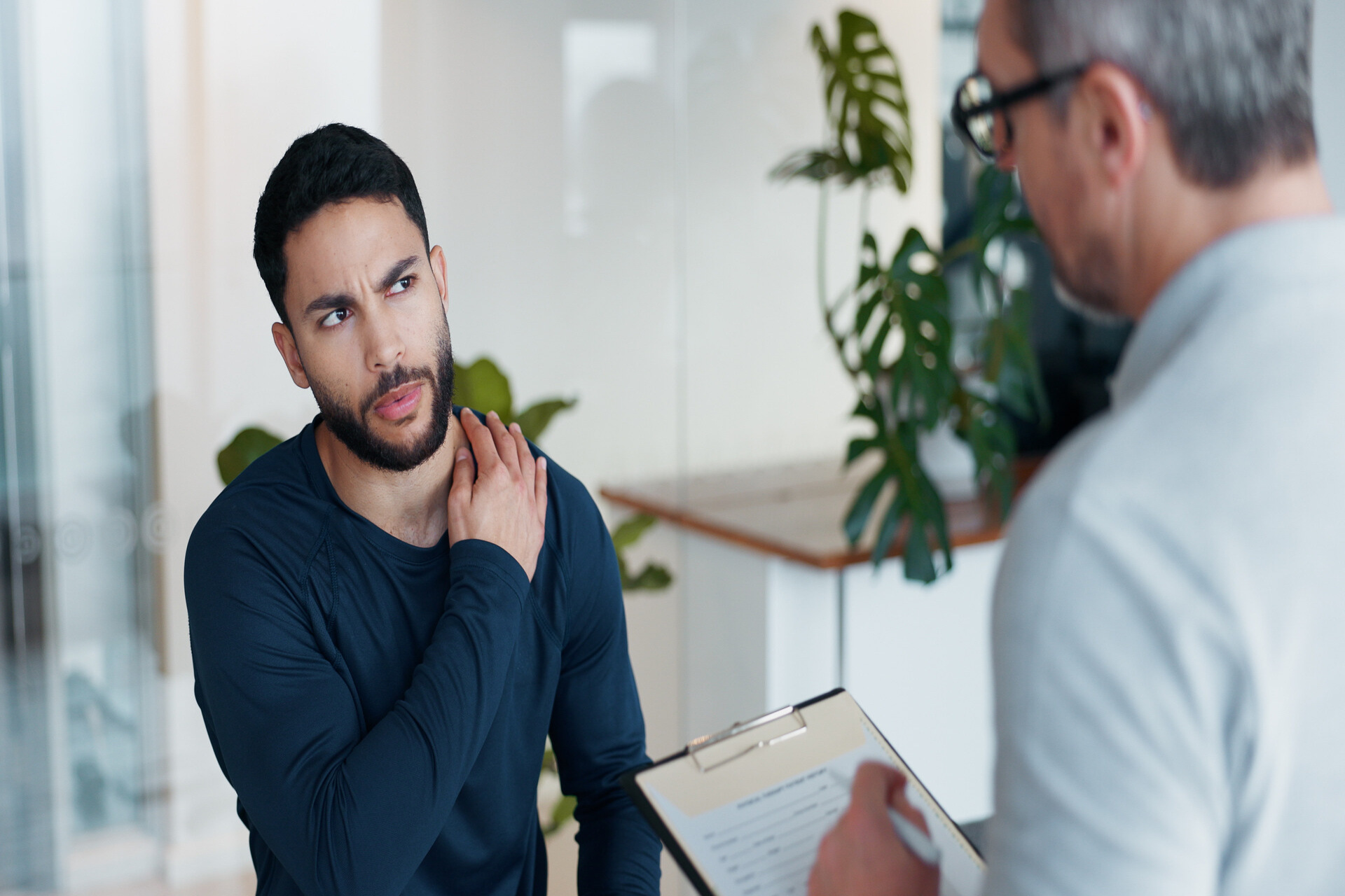 man with neck problems speaking with lawyer